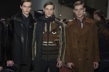 Three models looking at the camera wearing black, green and brown jackets