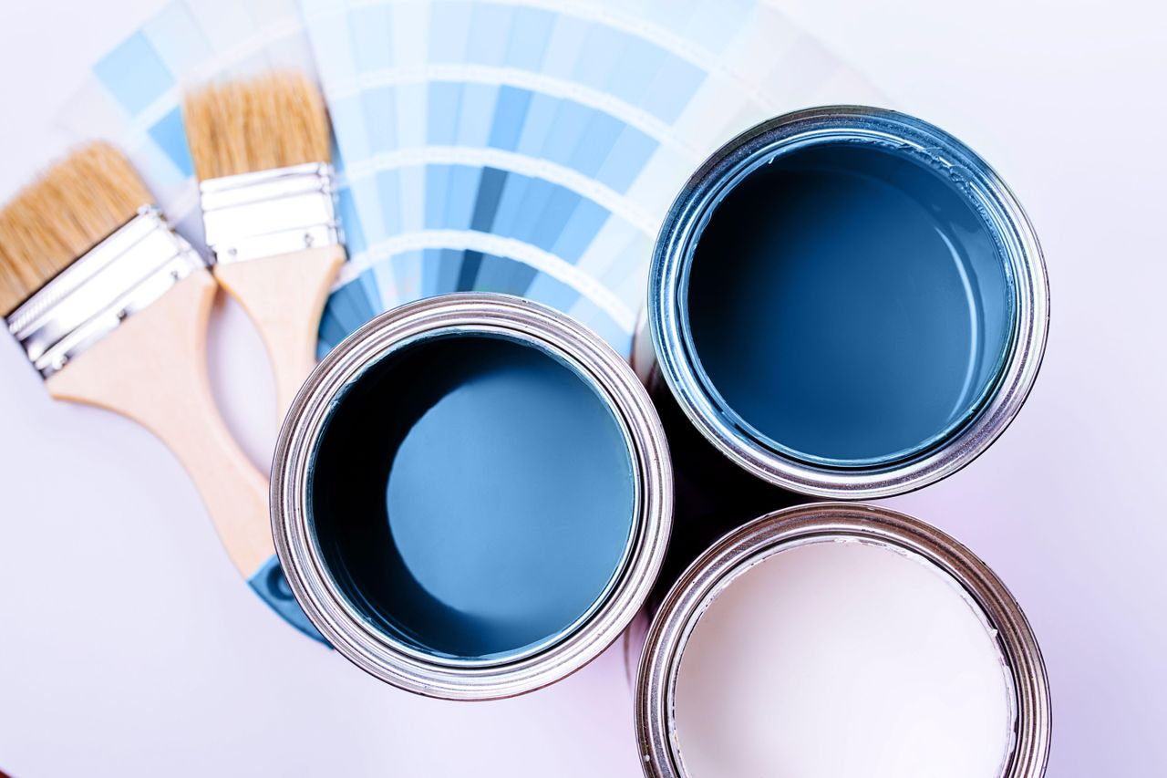 Open paint cans, color charts and paint brush Satin vs eggshell paint