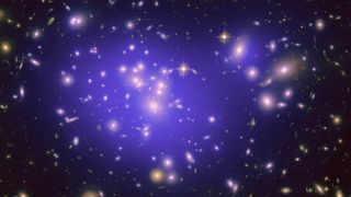This image shows hundreds of galaxies and a large purple "cloud" in the center.