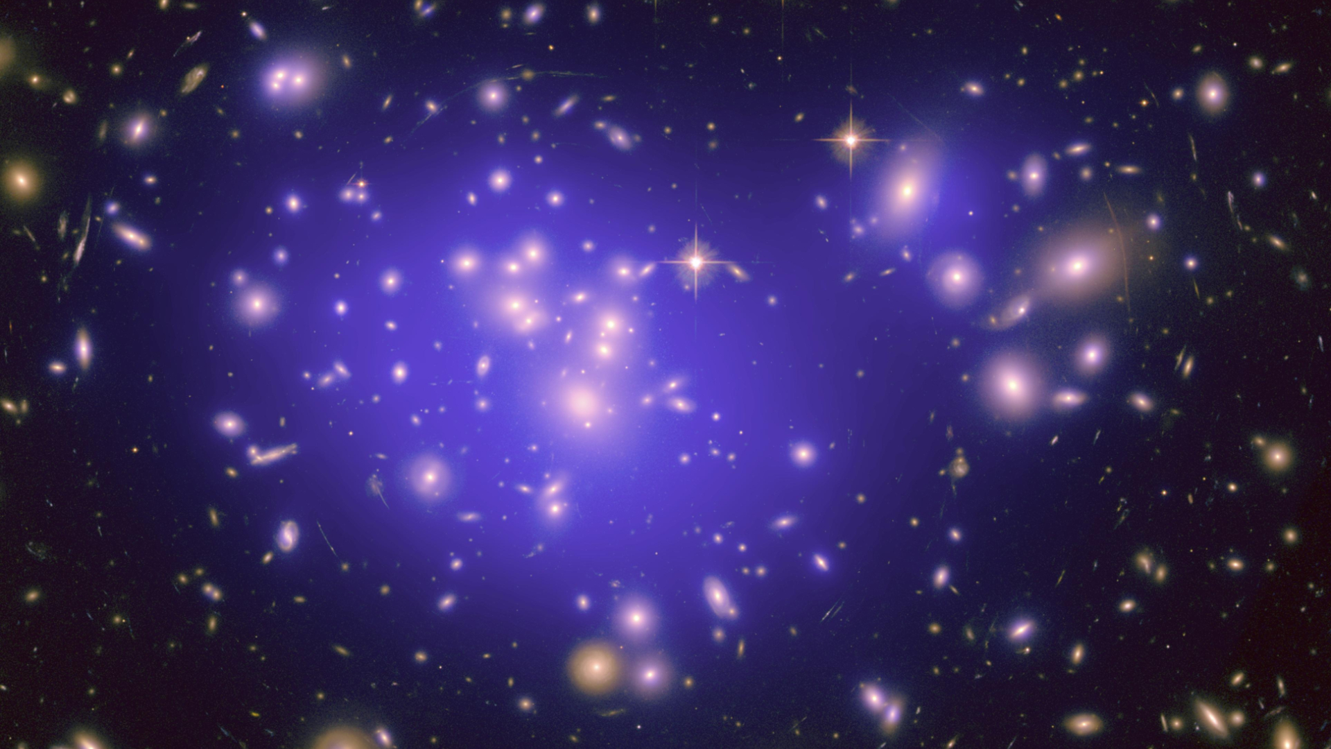 This image shows hundreds of galaxies and a large purple 