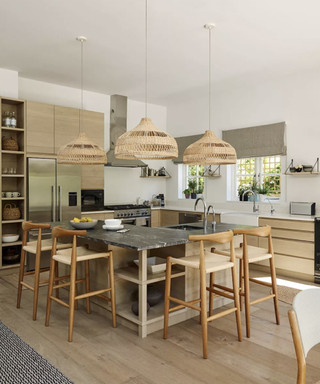 Wooden pendant kitchen lights design in a white and pale wood kitchen.