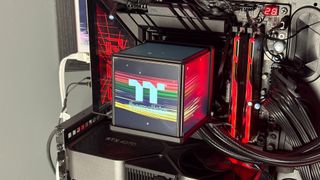 The Thermaltake Minecube 360 Ultra ARGB Sync set up on an open test bench.