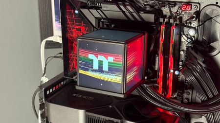 The Thermaltake Minecube 360 Ultra ARGB Sync set up on an open test bench.