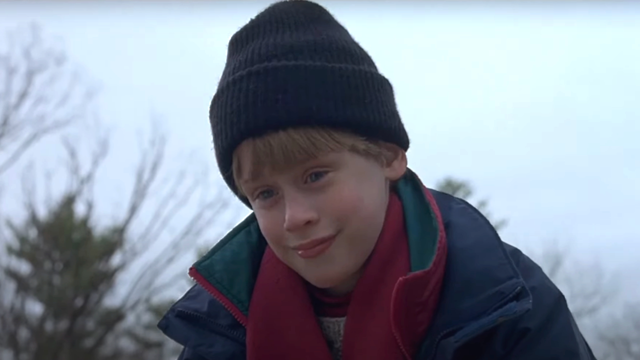 Macaulay Culkin wearing an evil smile outdoors in The Good Son.