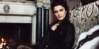 The Favourite Rachel Weisz sitting in front of a fire, listening to the Queen intently
