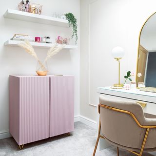 home office with desk and chair and pink cabinet