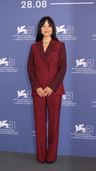 Jenna Ortega wearing burgundy suit