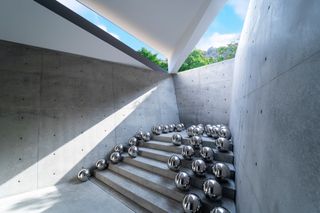 Installation showing shiny balls inside Tadao Ando designed Valley Gallery in Japan