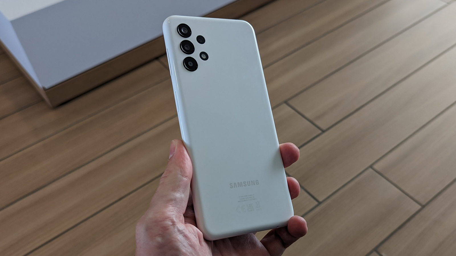 The back of the Samsung Galaxy A13 being held in a hand