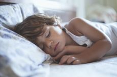 A stock photo of a small boy sleeping, used to illustrate a World Sleep Day article on how to get your child to sleep