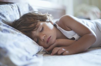 A stock photo of a small boy sleeping, used to illustrate a World Sleep Day article on how to get your child to sleep