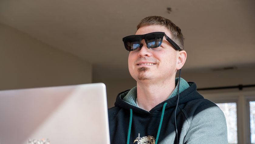 Wearing a pair of Xreal One smart glasses while working on a laptop