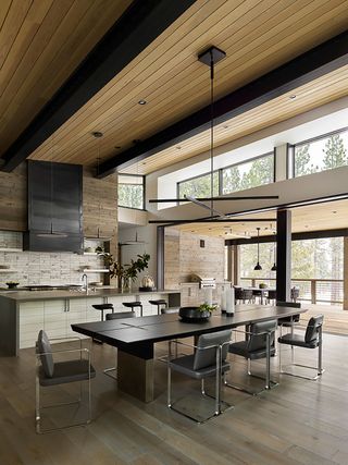 open plan dining kitchen with gray chairs and black table