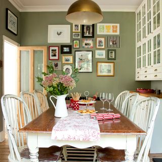 dining room with dining table chairs and framed artwork on the wall