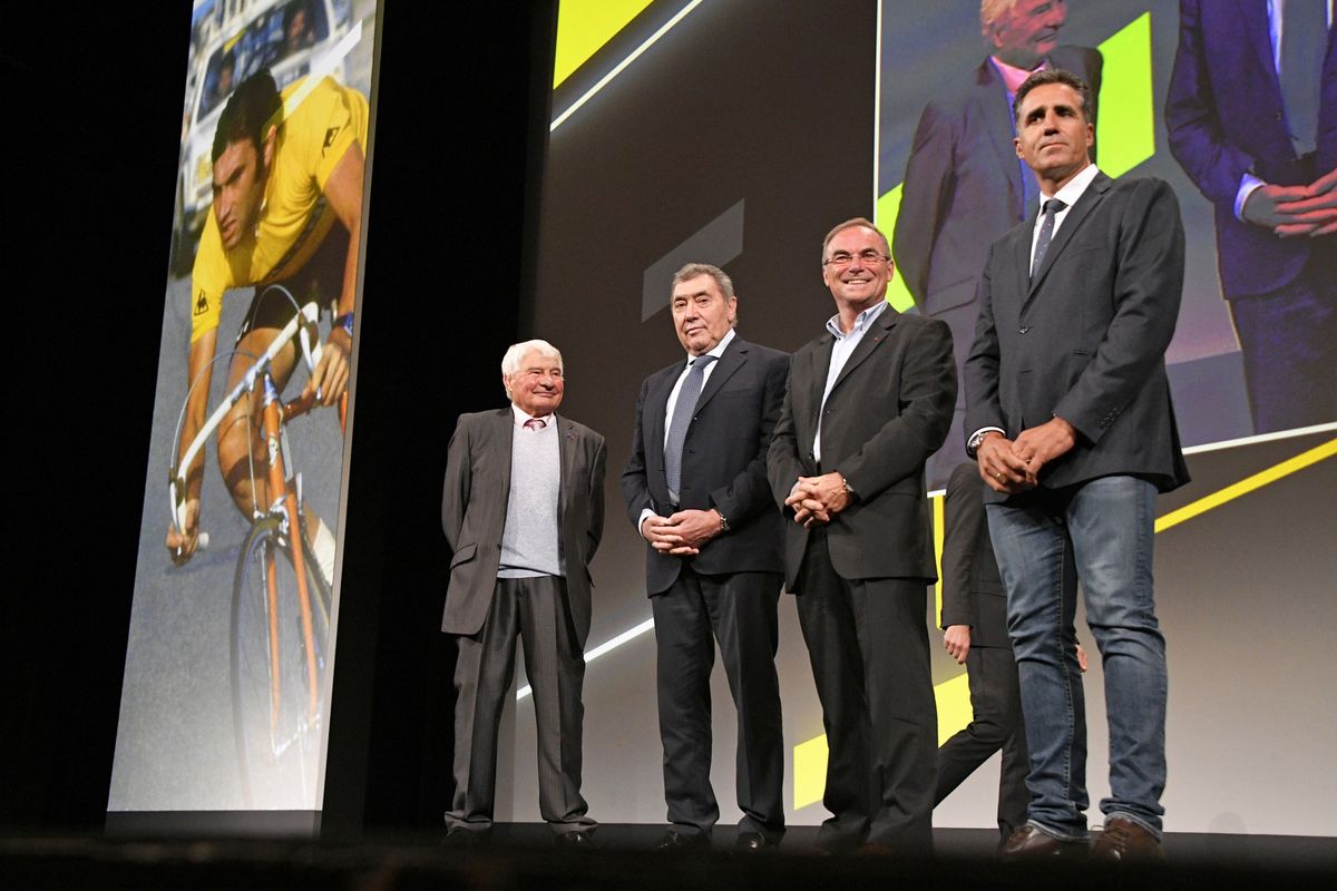 The five-time Tour de France winners and Raymond Poulidor on stage