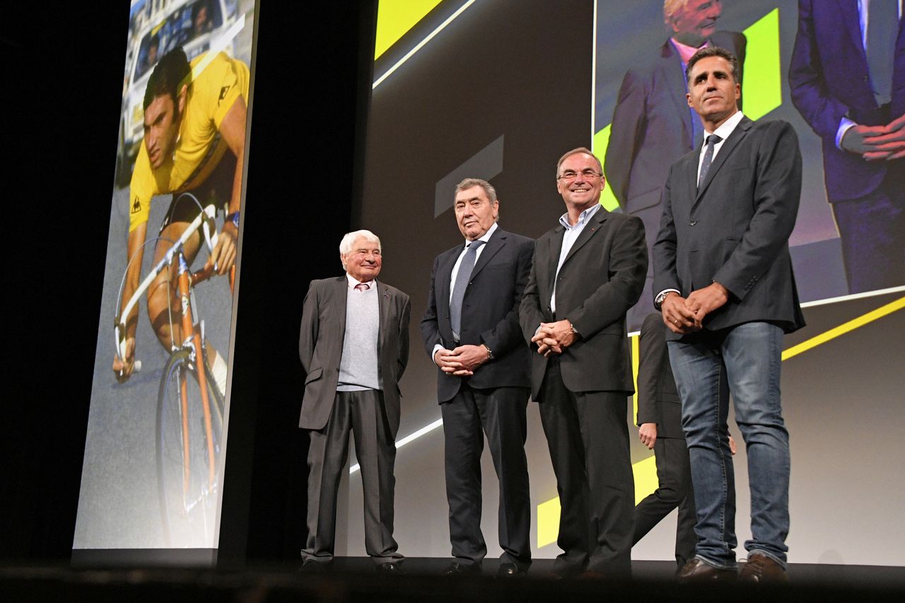 The five-time Tour de France winners and Raymond Poulidor on stage