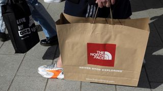 A shopper with a North Face bag