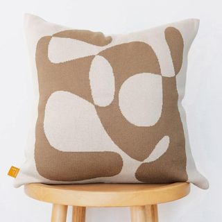 A brown and white throw pillow from Amazon