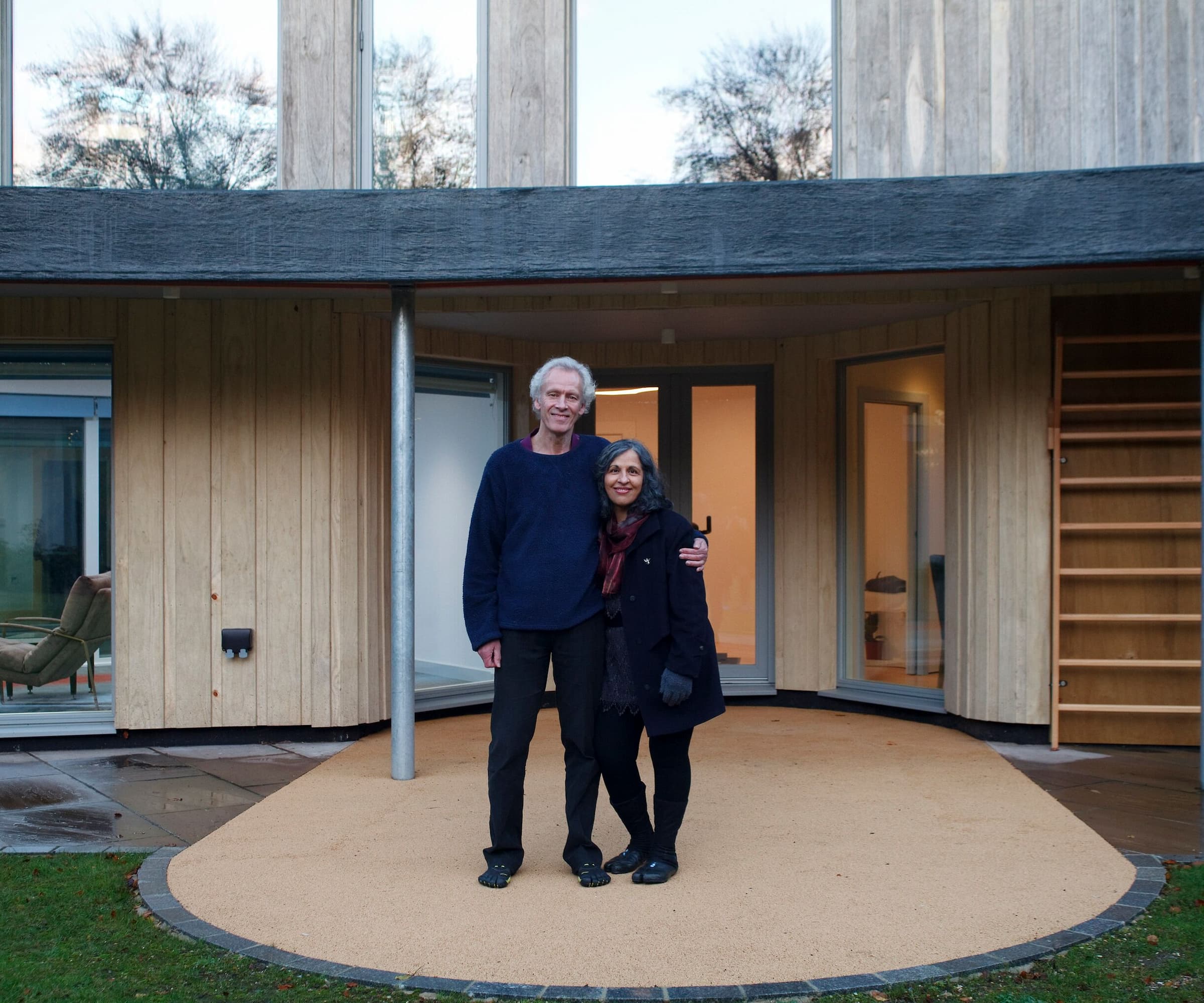 A couple stood in their garden on a paved walkway