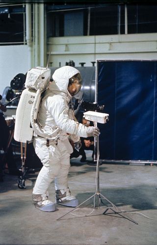 Neil Armstrong practices deploying a television camera during training before his flight on Apollo 11.