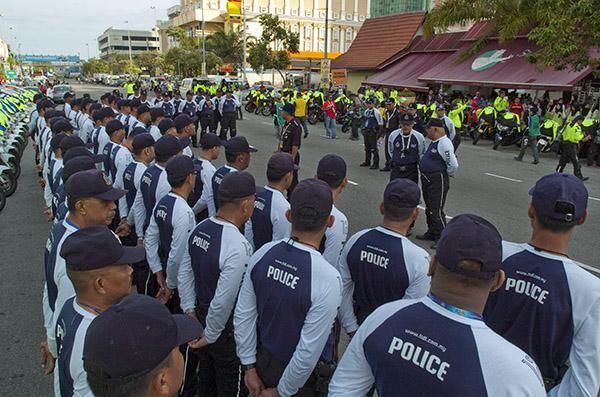 Safety in numbers: The police on the tour go through their ritual pre-stage routine.