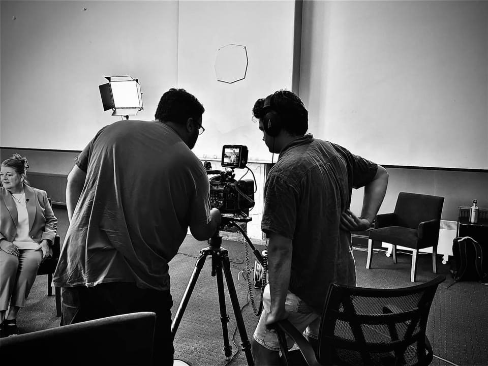 two men looking at a camera