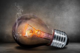 An illustration of a light bulb with a crack in it and smoke coming out.