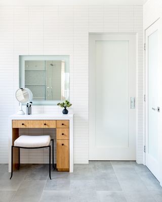 built-in makeup counter in white bathroom with subway tiles by LH.Designs