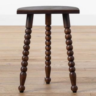 A wood stool with detailing on the legs from McGee & Co.