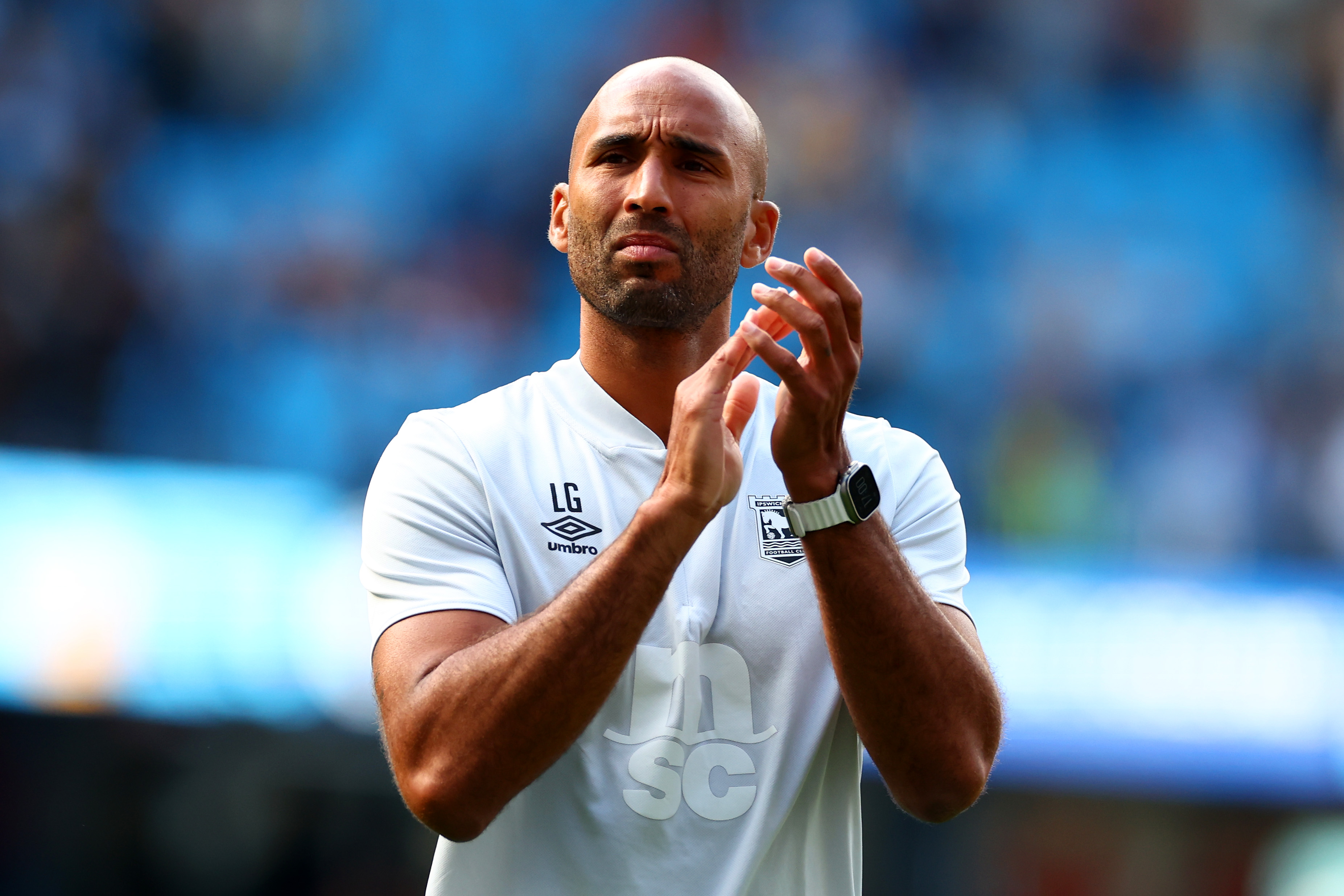 Ipswich Town coach Lee Grant applauds the fans