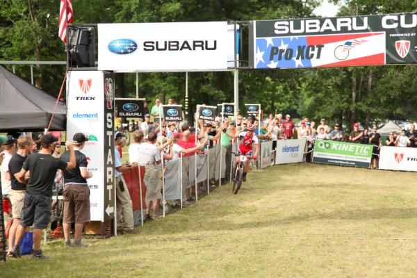 Max Plaxton (Specialized) has time to receive congratulations on his way to the finish.
