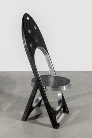 Black folding chair by Samuel Ross