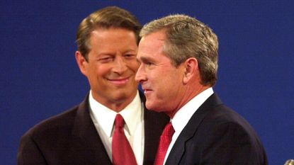 George W. Bush shakes hands with Al Gore before a debate in 2000.