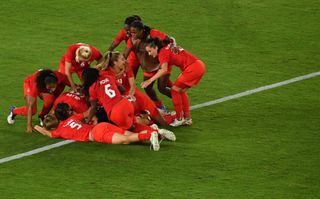 Canada players celebrate after beating Sweden on penalties in the final of the women's football tournament at the Tokyo 2020 Olympics.