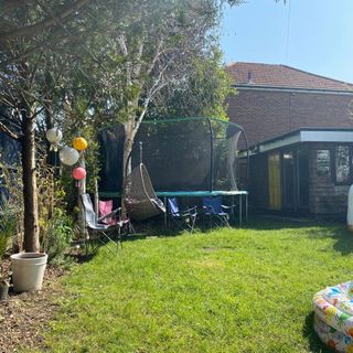 garden with trampoline and hanging swing