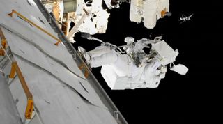 NASA astronaut Mark Vande Hei works on the latching end effector, or the "hand" at the end of the Canadarm2 robotic arm.