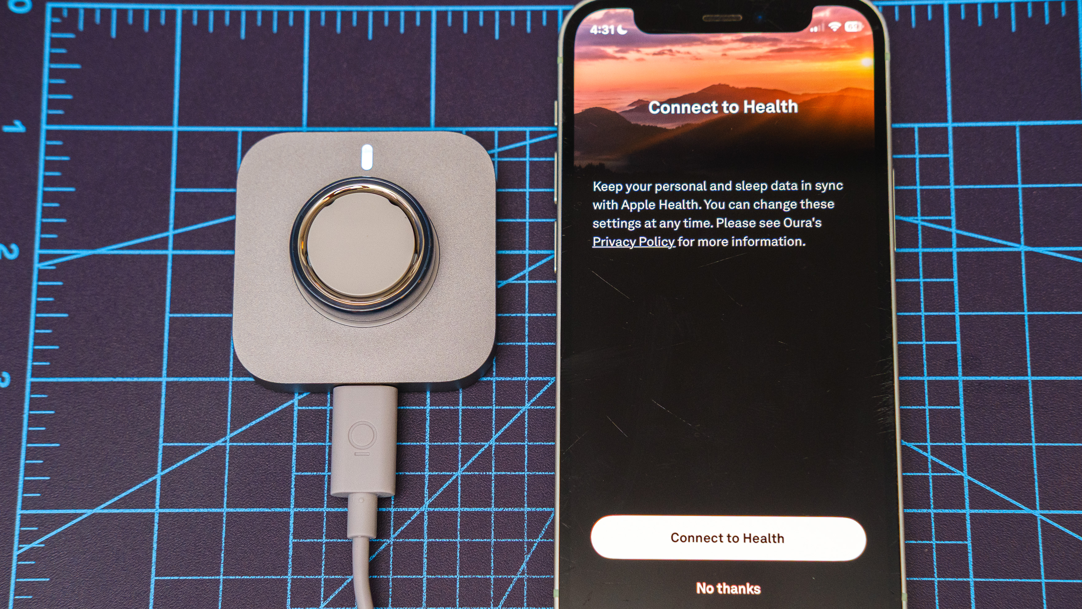 Oura Ring 4 Ceramic close-up showing the setup and pairing process using an iPhone
