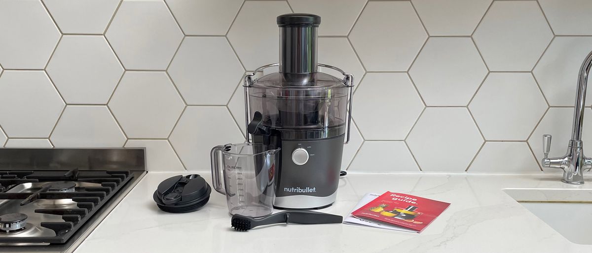 Nutribullet Juicer on a kitchen countertop surrounded by its accessories