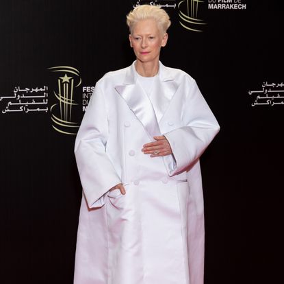 Tilda Swinton in an oversized white coat at the 2023 Marrakech International Film Festival in Morocco