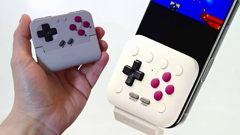 Close up of 8Bitdo FlipPad on right attached to phone next to hand holding Gamesir Pocket Taco on left.