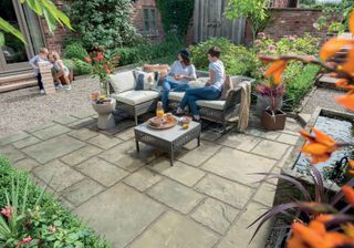 eco patio ideas using bradstone eco paving with family sat on outdoor furniture