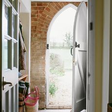 door way with surrounding exposed brick wall