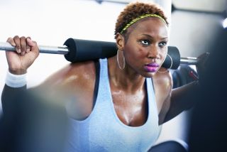 A close up of a woman lifting weights