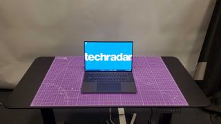 Dell XPS 15 (2023) sitting on purple desk