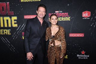 Dafne Keen and Hugh Jackman smiling on the Deadpool 3 red carpet