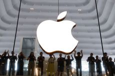 Apple logo in store with employees standing below.