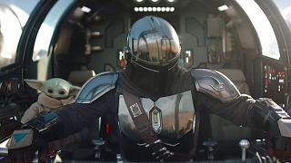 Pedro Pascal as The Mandalorian and Grogu are shown in the trailer for The Mandalorian and Grogu.