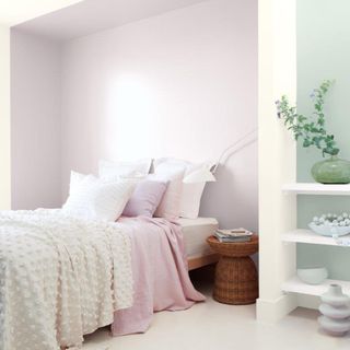 bedroom with pastel pink and mint green colour block paint on walls