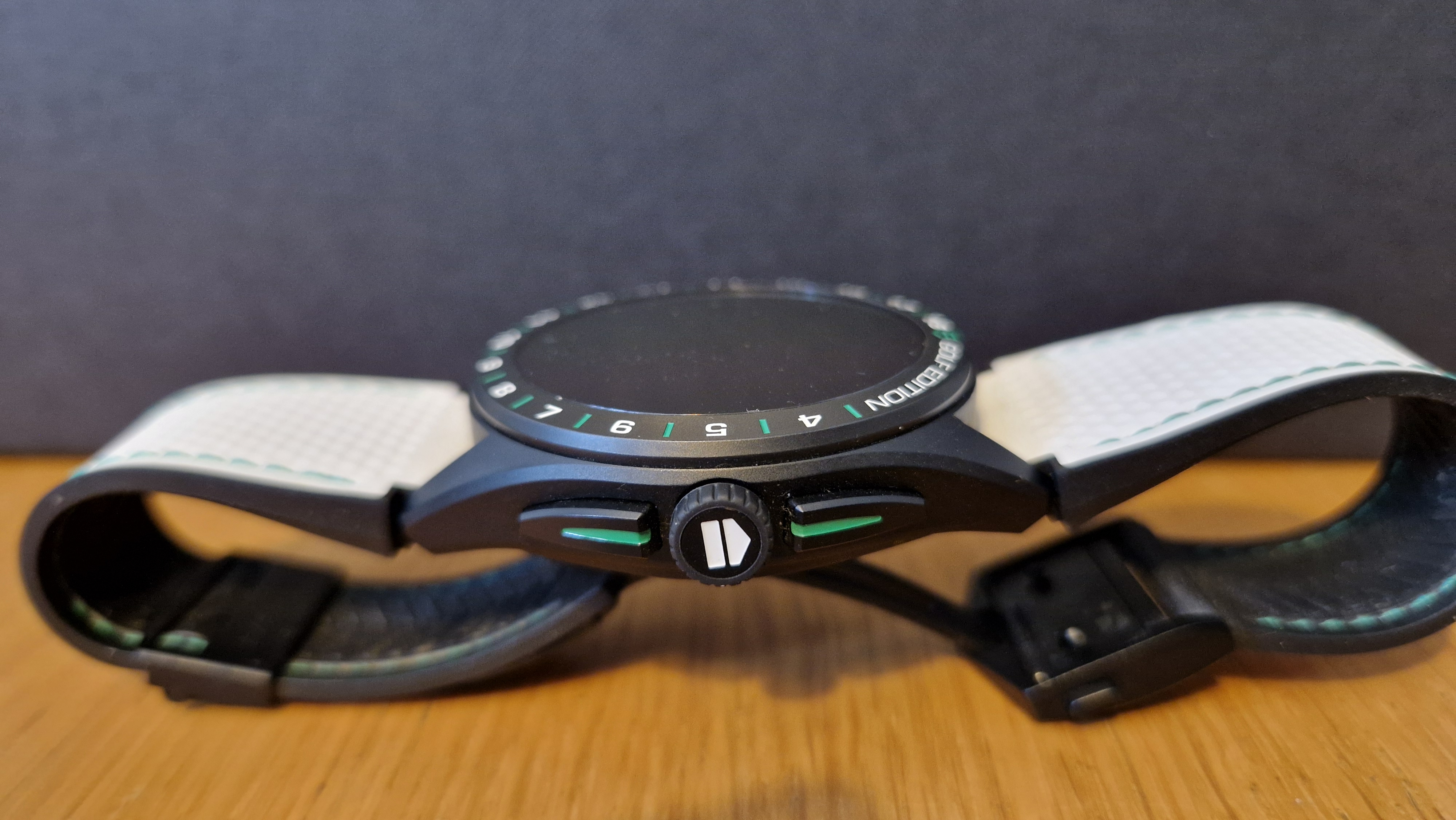 TAG Heuer Connected Calibre E4 Golf Edition on a wooden table with its box behind it