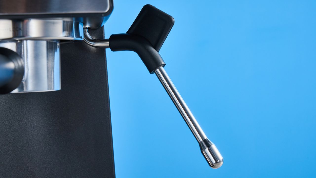 The Cuisinart Espresso Bar Slim espresso machine on a stone surface with a blue background